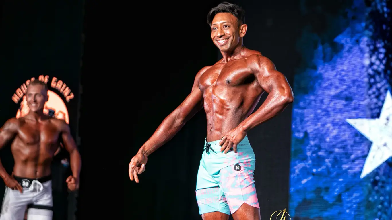 Dr. Shiv Goel on stage at IFBB competition, keynote speaker and former IFBB pro.
